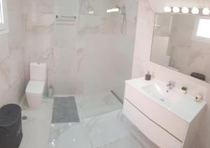 Baño blanco con lavabo y aseo en Casa D`Avó Joana, en Ponta Delgada