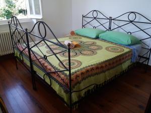 a bedroom with a bed with a metal frame at Trekking in paradise B&B in Santa Margherita Ligure