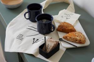 a table with a plate of food and two cups of coffee at San Luis Creek Lodge in San Luis Obispo +22 photos