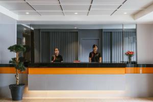 two women are standing behind a counter in a lobby at Season Place in Bangkok