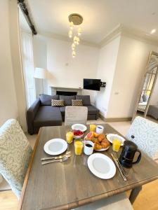 a white table topped with plates of food at Stylish Apartments in Pimlico & Westminster in London