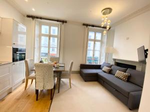 a living room filled with furniture and a table at Stylish Apartments in Pimlico & Westminster in London