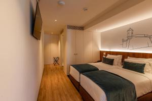 Кровать или кровати в номере Sea Porto Hotel