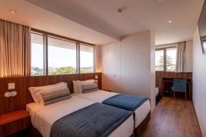 Кровать или кровати в номере Sea Porto Hotel