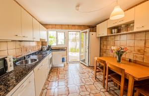 a kitchen with a wooden table and a wooden table sidx sidx sidx at Es Norai 18 in Cala Ratjada