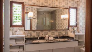 a bathroom with two sinks and a large mirror at Es Norai 18 in Cala Ratjada +33 photos