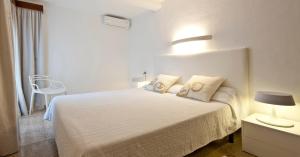 a bedroom with a bed with two pillows on it at Es Norai 18 in Cala Ratjada