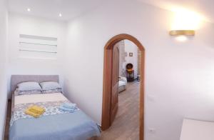 a bedroom with a bed and an open doorway at Apartment Fritula Istriana in Koper