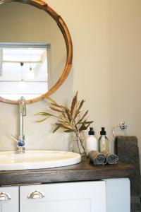 a bathroom with a sink and a mirror at Avo&Oak Guesthouse in George