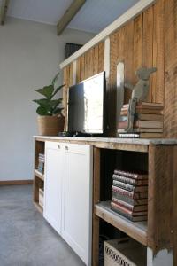 a desk with a computer and books on it at Avo&Oak Guesthouse in George