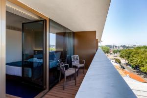 a balcony with a bedroom and a bed at Sea Porto Hotel in Matosinhos