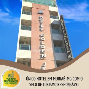 a building with a hotel sign in front of it at Hotel Golden JK in Muriaé