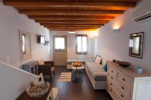 a living room with a couch and a table at Aliktypo Studios in Livadi