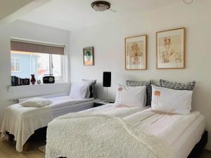 a bedroom with two beds and a window at Skólavörðustígur Apartments in Reykjavík