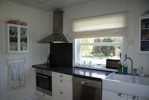 a kitchen with a counter and a sink and a window at Bed and breakfast in Sauda