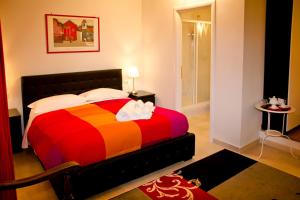 een slaapkamer met een bed met een kleurrijke deken bij Vatican Dream in Rome