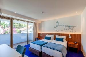 Кровать или кровати в номере Sea Porto Hotel