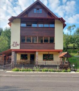 a building with a fence in front of it at La Gabi in Azuga +22 photos