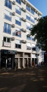 a large white building with windows and balconies at Apartman Savić in Bar