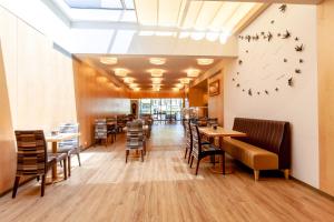 a restaurant with tables and chairs and birds on the wall at Sea Porto Hotel in Matosinhos