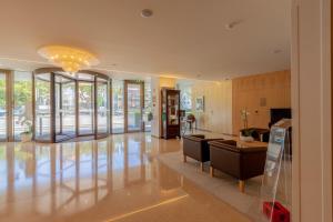 a living room with a lobby with a chandelier at Sea Porto Hotel in Matosinhos