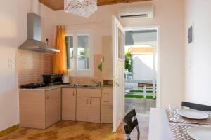 a kitchen with a sink and a stove top oven at Zoumpouli Village in Spartià