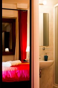 een slaapkamer met een rood bed en een wastafel bij Vatican Dream in Rome