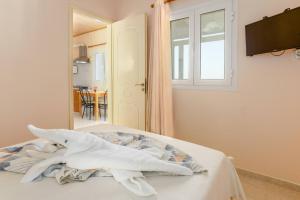 a bedroom with a bed with towels on it at Zoumpouli Village in Spartià +97 photos