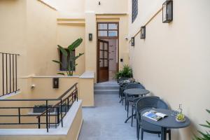 a corridor of a restaurant with tables and chairs at Camere Maritima in Chania
