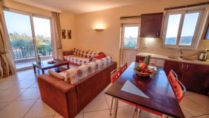 a kitchen and living room with a table and chairs at Agroktima Elia in Nafplio