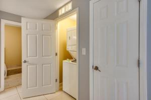 a white door leading into a kitchen with a washer and dryer at The Splash Resort and Condos East 2 in Panama City Beach