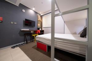 a bedroom with a bunk bed and a desk at Seoul N Hotel Dongdaemun in Seoul