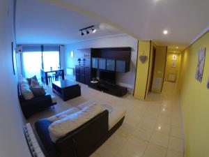 a large living room with a couch and a tv at 8Beds Vila-seca in Vila-seca