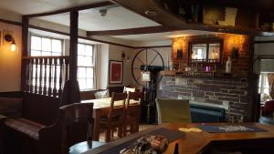 a dining room with a table and a fireplace at The Antelope at Upavon in Upavon