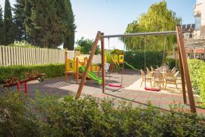a playground with a swing set and a table and chairs at Villa Aurora in St. St. Constantine and Helena