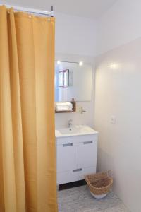 a bathroom with a sink and a shower curtain at Maria Tereza Sea Villa in Costa da Caparica
