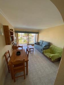 a living room with a couch and a table at Apartment Alcudia Beach in Port d'Alcudia