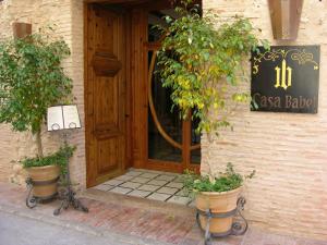 a doorway leading to a building with a sign on it at Hotel Casa Babel in Villalonga