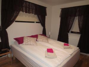 a bedroom with a bed with two towels on it at Teigur Guesthouse in Akranes