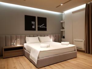 a bedroom with a large white bed in a room at ArtNest Luxury Hotel & Suites in Sarandë