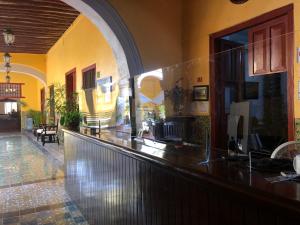 a restaurant with a counter in a building at Castelmar Hotel in Campeche
