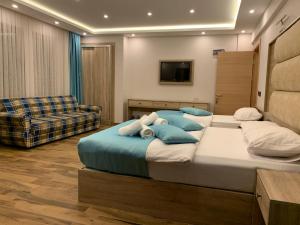 a bedroom with a large bed and a couch at Danis Otel Ve Restoran in Uzungol