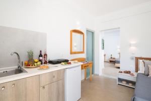 a kitchen with a sink and a counter with fruit on it at Finata Studios in Kavos +10 photos