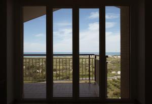 a window with a view of the ocean seen through it at Villa Largo Belvedere in Campomarino