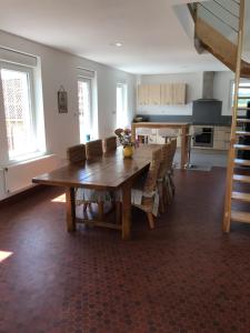 a dining room with a wooden table and chairs at Gîte dans le pré Hesdin l'abbé in Carly