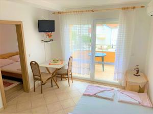 a living room with a table and a bedroom at Pranjic Delux Guest House in Vodice +32 photos