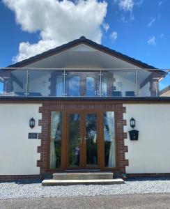 a house with a large glass door at BriValley View in High Bickington