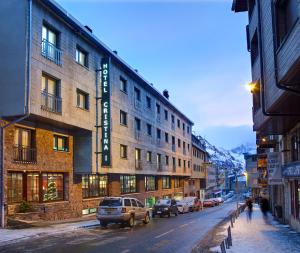 a city street with cars parked in front of a building at Hotel Cristina in Pas de la Casa