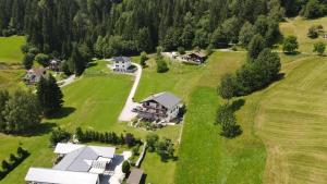 an aerial view of a house on a green field at Gailtal Panorama in Kötschach