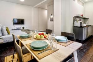 a dining room with a table with a bowl of fruit on it at Nice Euapartments in the center in Grodno
